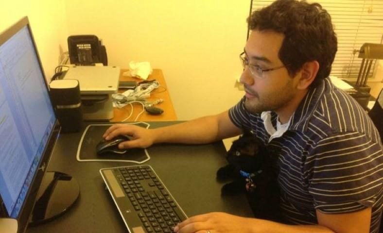 Image of man searching on internet with cat