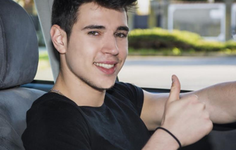 Image of happy guy in car giving thumbs up